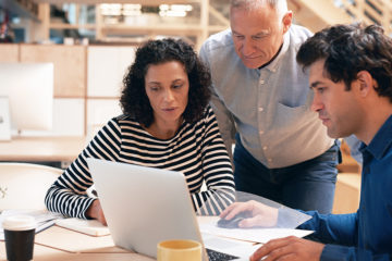Person is teaching coworkers how to lower inflation in roofing.