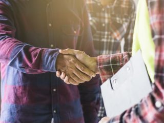 people shaking hands signifying good customer service through roofing software.