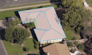 Aerial image of a house being mapped out with roof measuring software. 