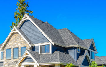 Picture of a house with a gray roof and blue siding