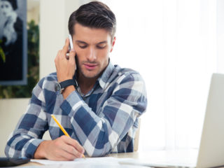 man using crm for contractors to call crews