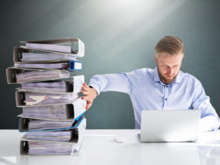 man pushing away paper while using esign software