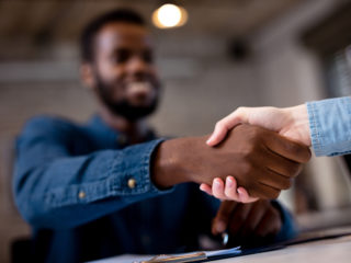 handshake showing roofing sale