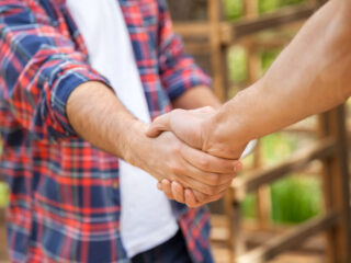 Shaking hands signifying a sale made.