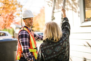 Roofer talking to homeowner