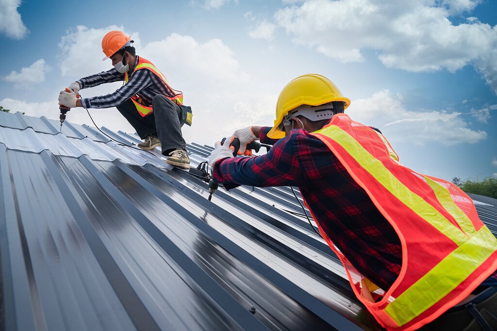 Roofing professionals working on durable, climate-resistant roofing installation.