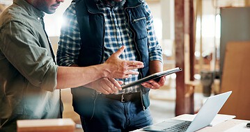 people aligning roofing systems with technology
